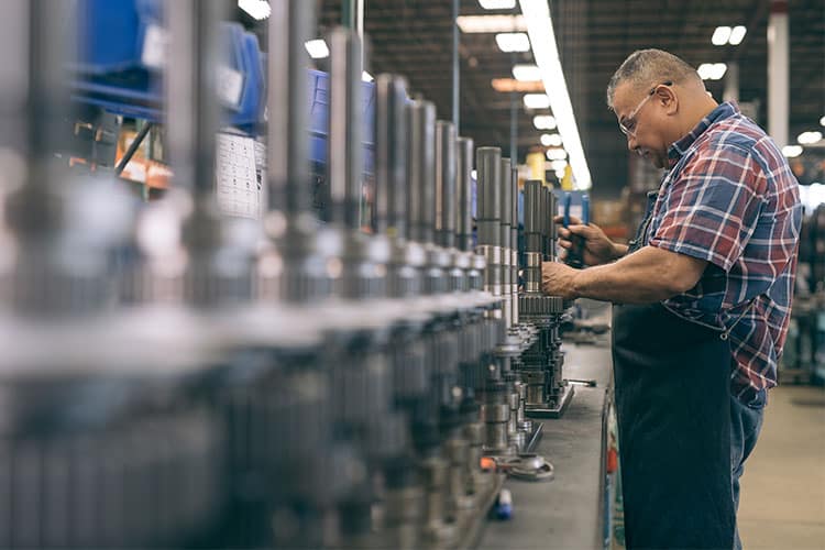 Dynamic Manufacturing staff in warehouse working on machining